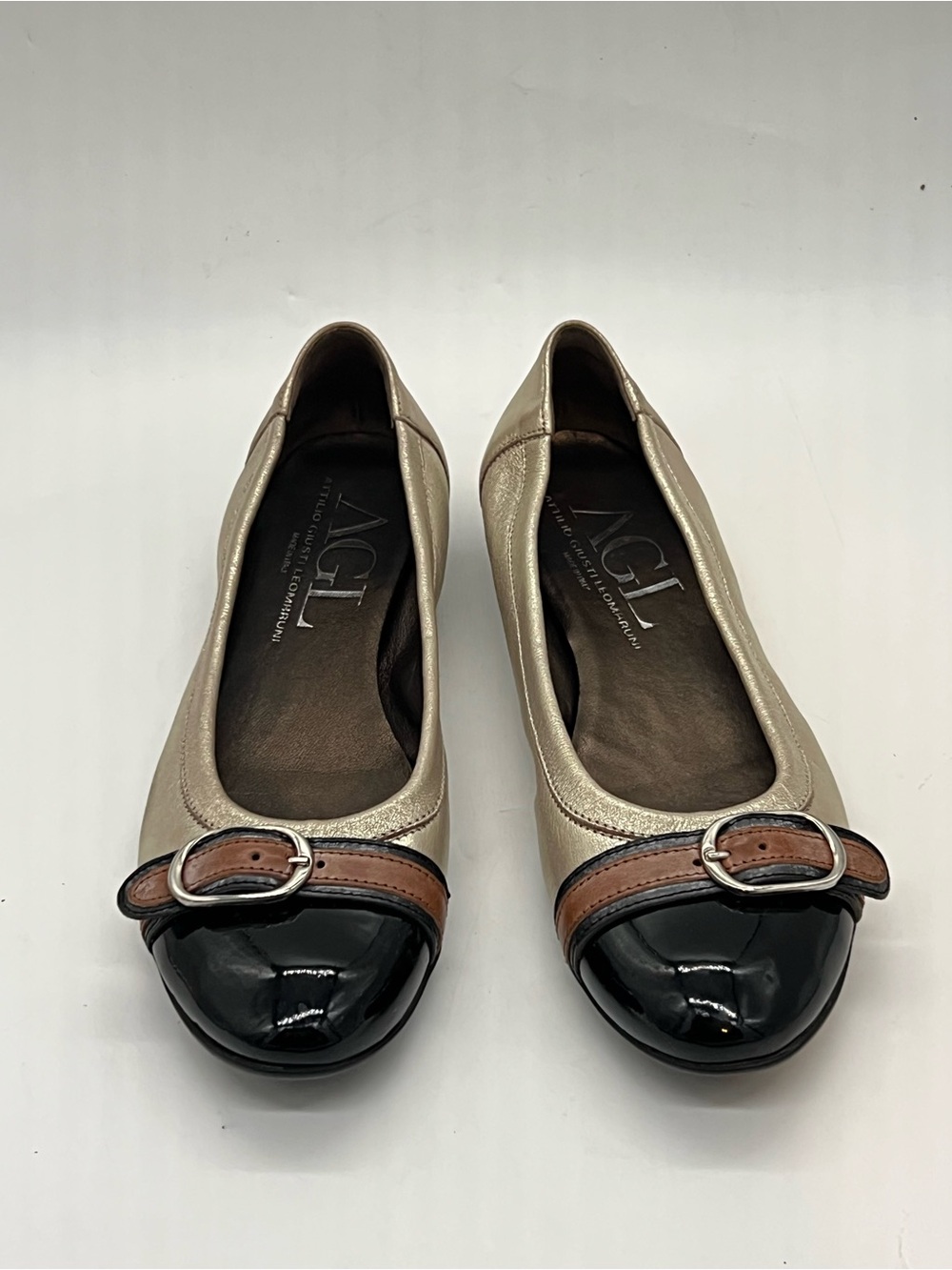 AGL Gold Leather Ballet Flats with Black Patent Cap-Toe and Brown Buckle